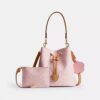 Borsa a secchiello Rowan in Signature Canvas con ciondoli