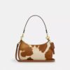 Borsa a spalla Teri in pelle di vitello con stampa bovina