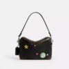 Borsa a tracolla Dakota per il decimo compleanno di Rexy in pelle "Loved" con stampa adesivi
