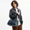 Borsa Compass 35 in denim di cotone rigenerativo con ciondoli