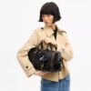 Borsa Compass 35 in pelle invecchiata con ciondoli