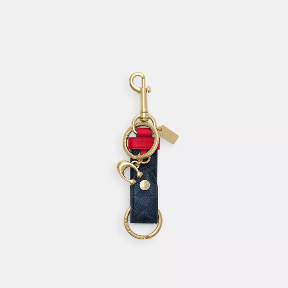 Ciondolo per borsa con chiusura a scatto in Signature Canvas con ciondolo