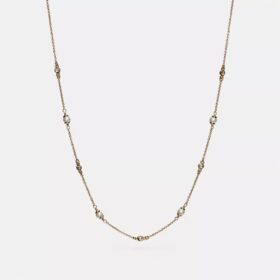 Collana con perle a forma di C scolpite
