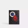 Custodia per passaporto in Signature Canvas con toppe