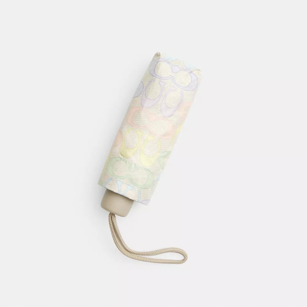 Mini ombrello con protezione UV nella stampa arcobaleno firmata
